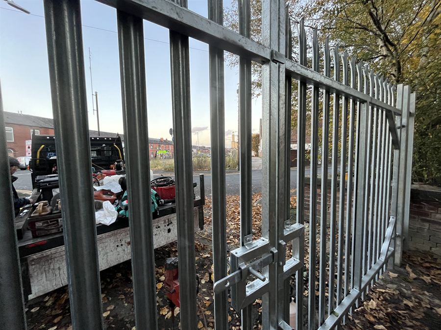 Galvanised palisade gates at the rear entrance of a factory